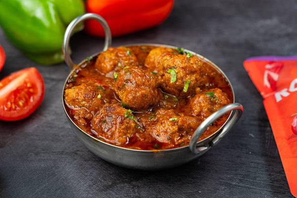 Kofta curry, spiced lamb meatballs in a rich Rogan Josh sauce, served in a balti dish